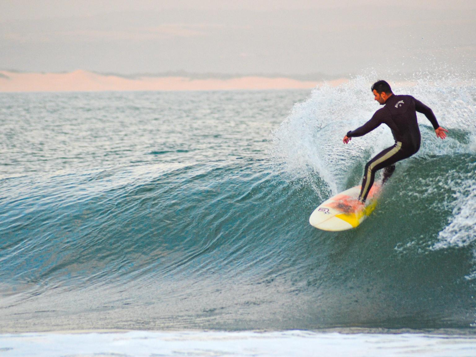 a man is riding a wave on a surfboard in the ocean.