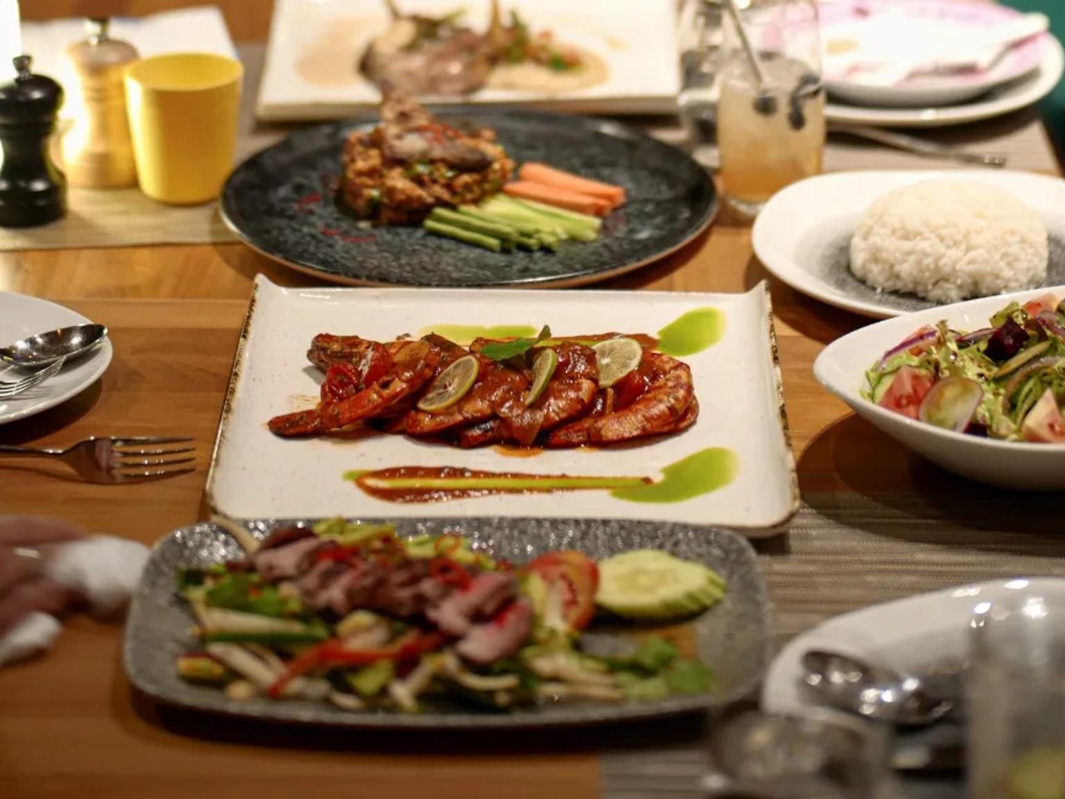 a table topped with plates of food and utensils