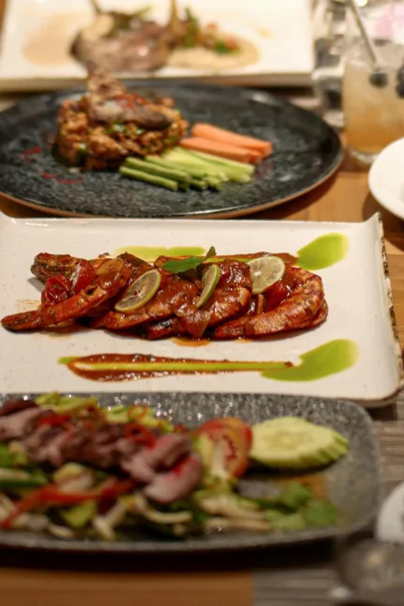 a table topped with plates of food and utensils