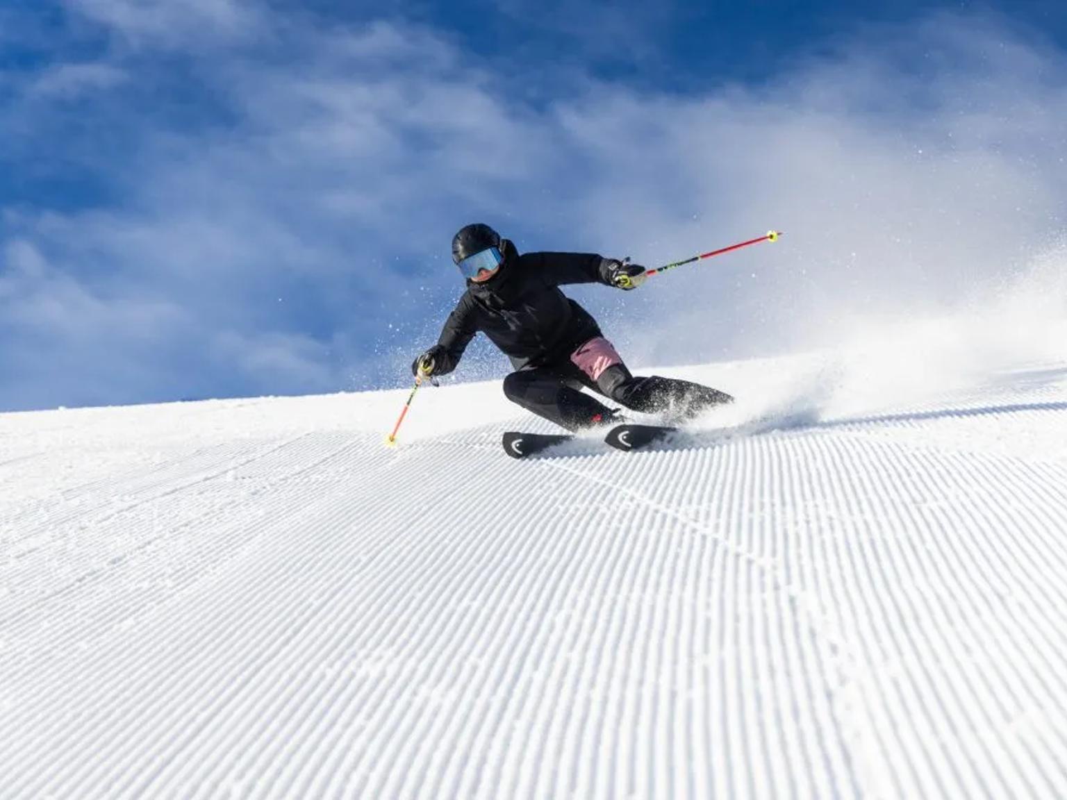 a person is skiing down a snow covered slope