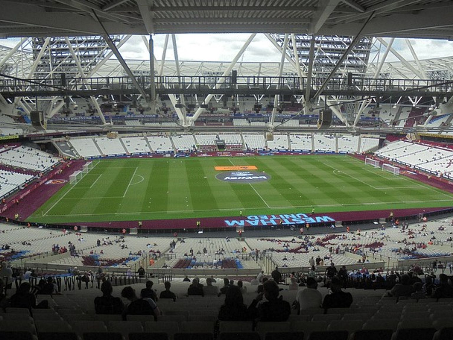 a soccer stadium filled with people watching a game