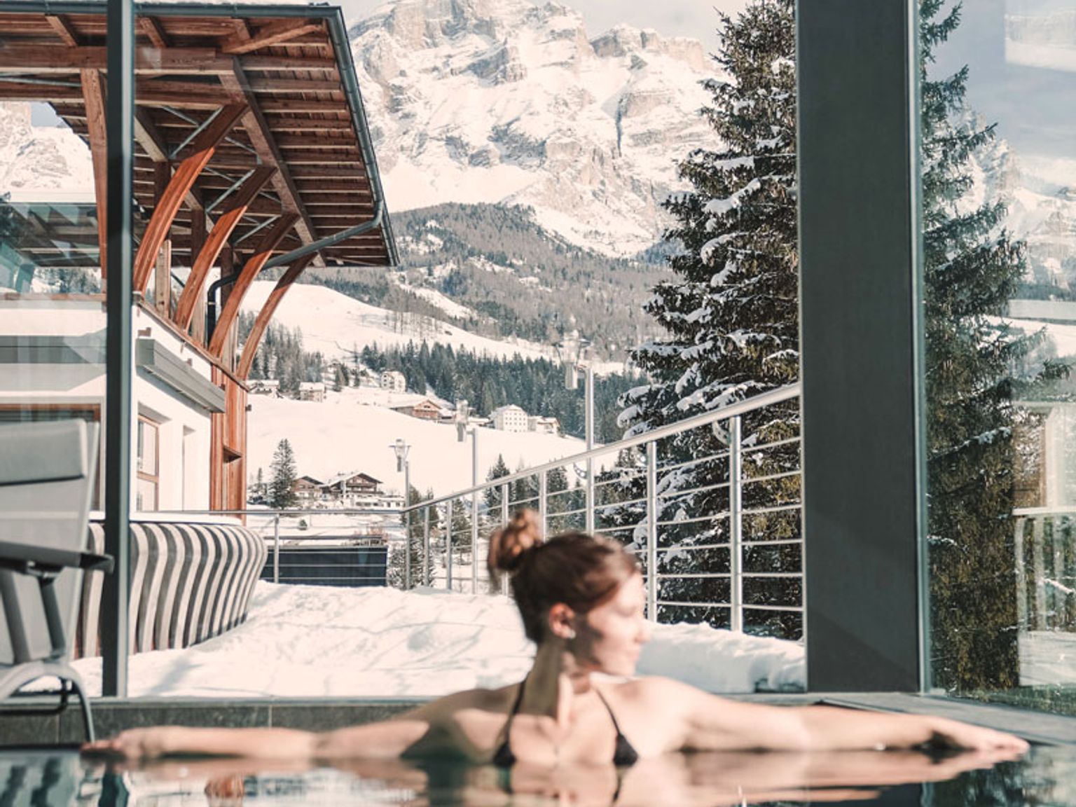 en kvinne ligger i et boblebad med fjell i bakgrunnen, Hotel Ciasa Soleil, Alta Badia.