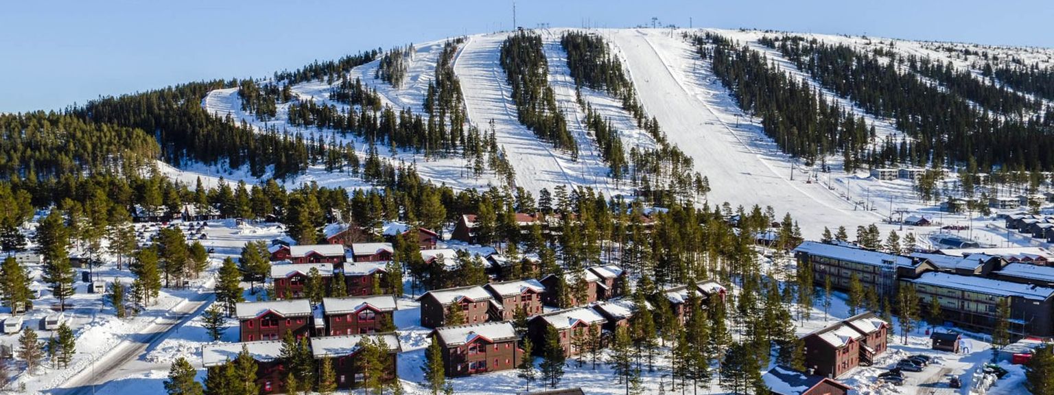 en flygvy av en skidort med en skidbacke i bakgrunden.
