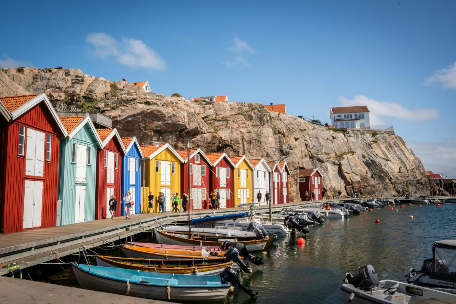 en rekke fargerike hus er stilt opp ved siden av hverandre på en dock