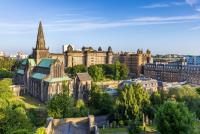 an aerial view of a city with a large cathedral in the middle of it.
