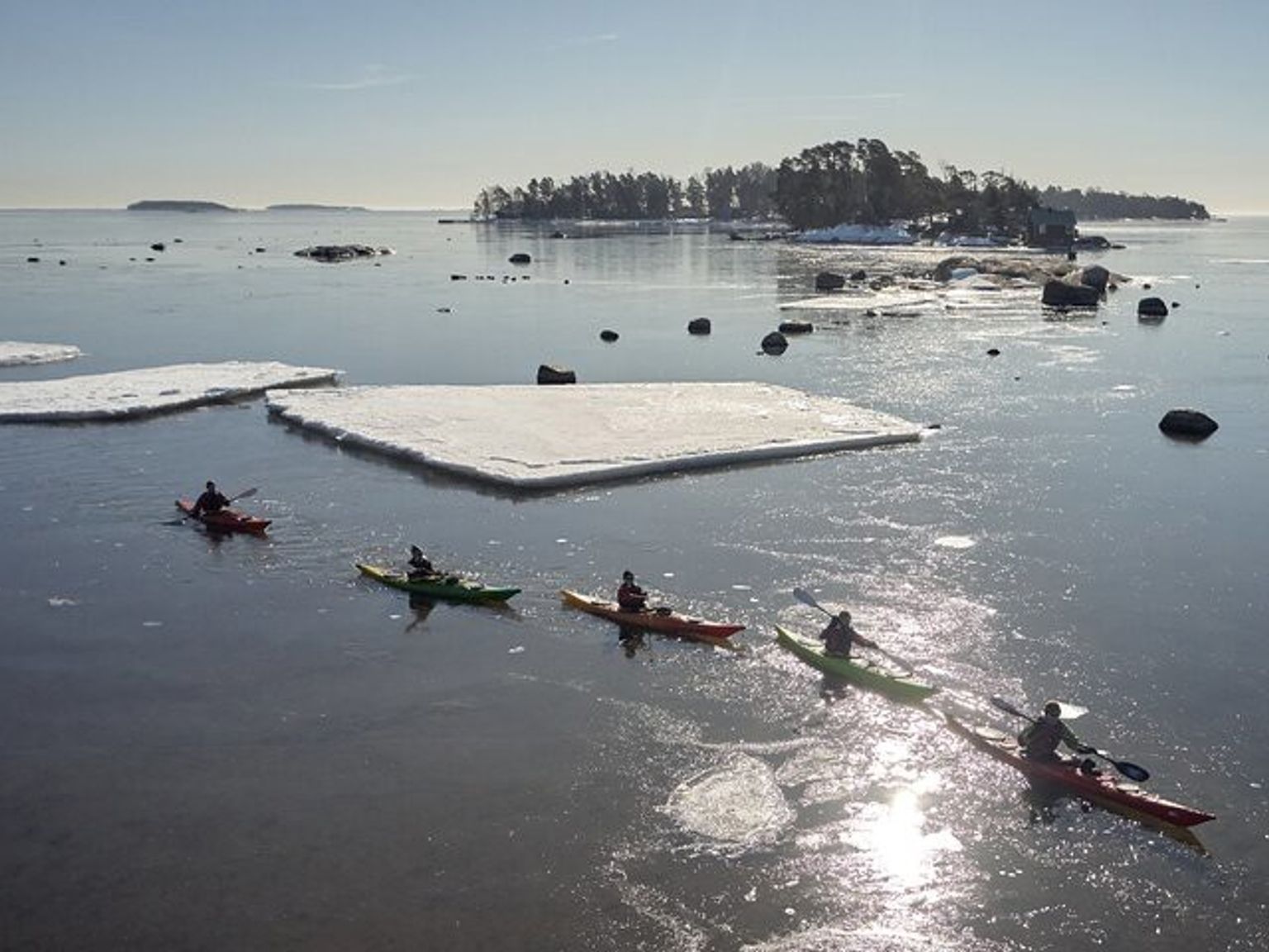 a group of people are rowing kayaks in the ocean