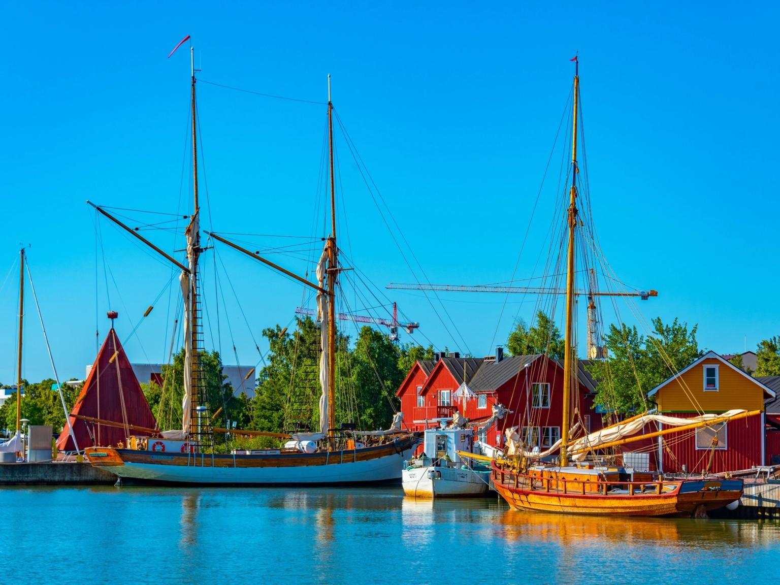 a group of sailboats are docked in a harbor