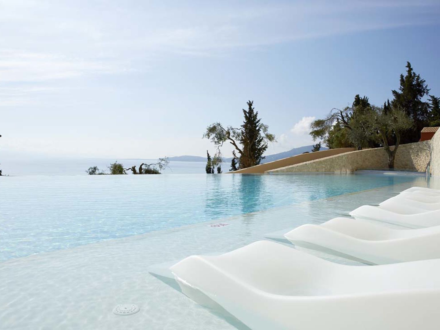 a swimming pool with a view of the ocean and mountains