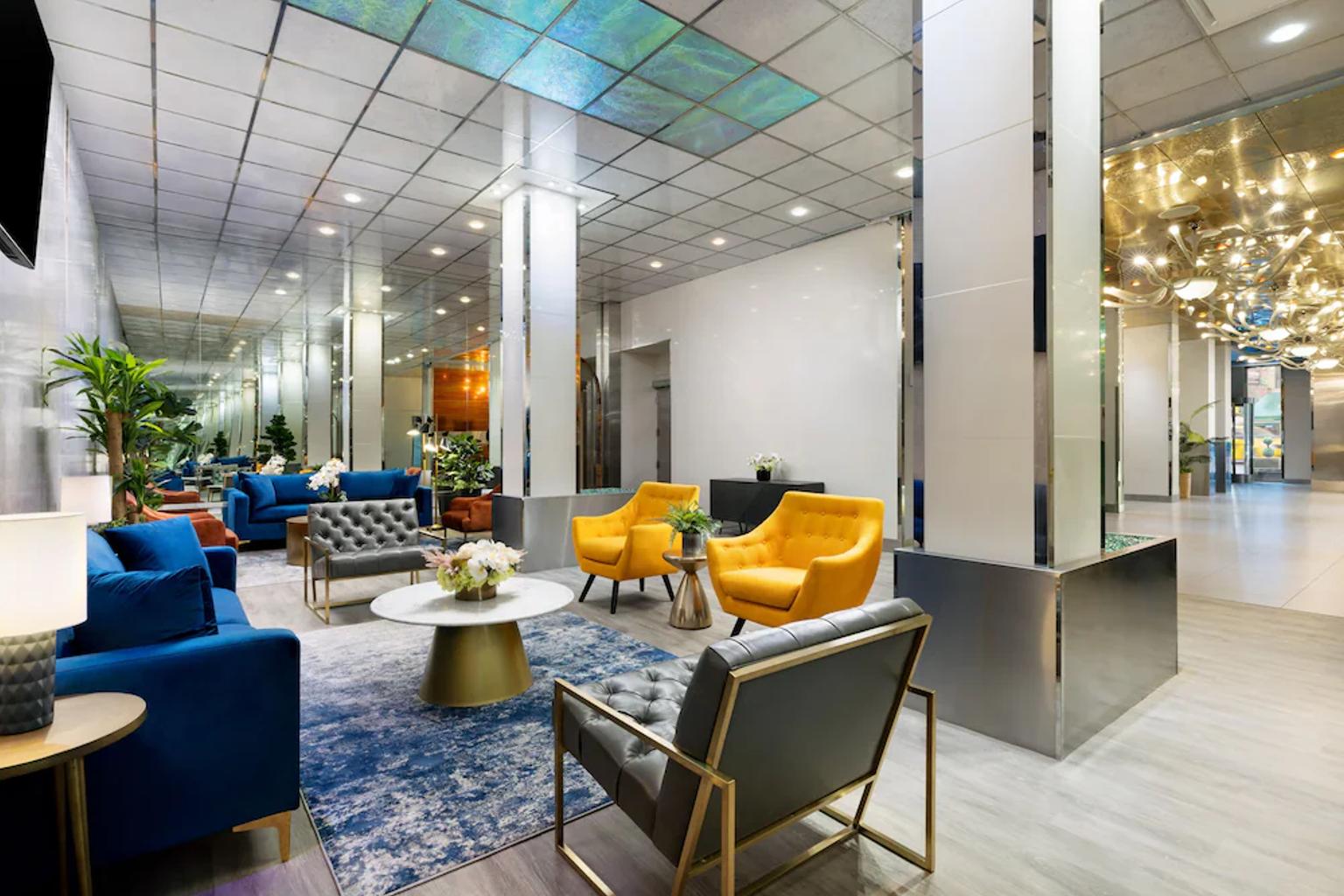 det er mange stoler og en sofa i lobbyen på et hotell