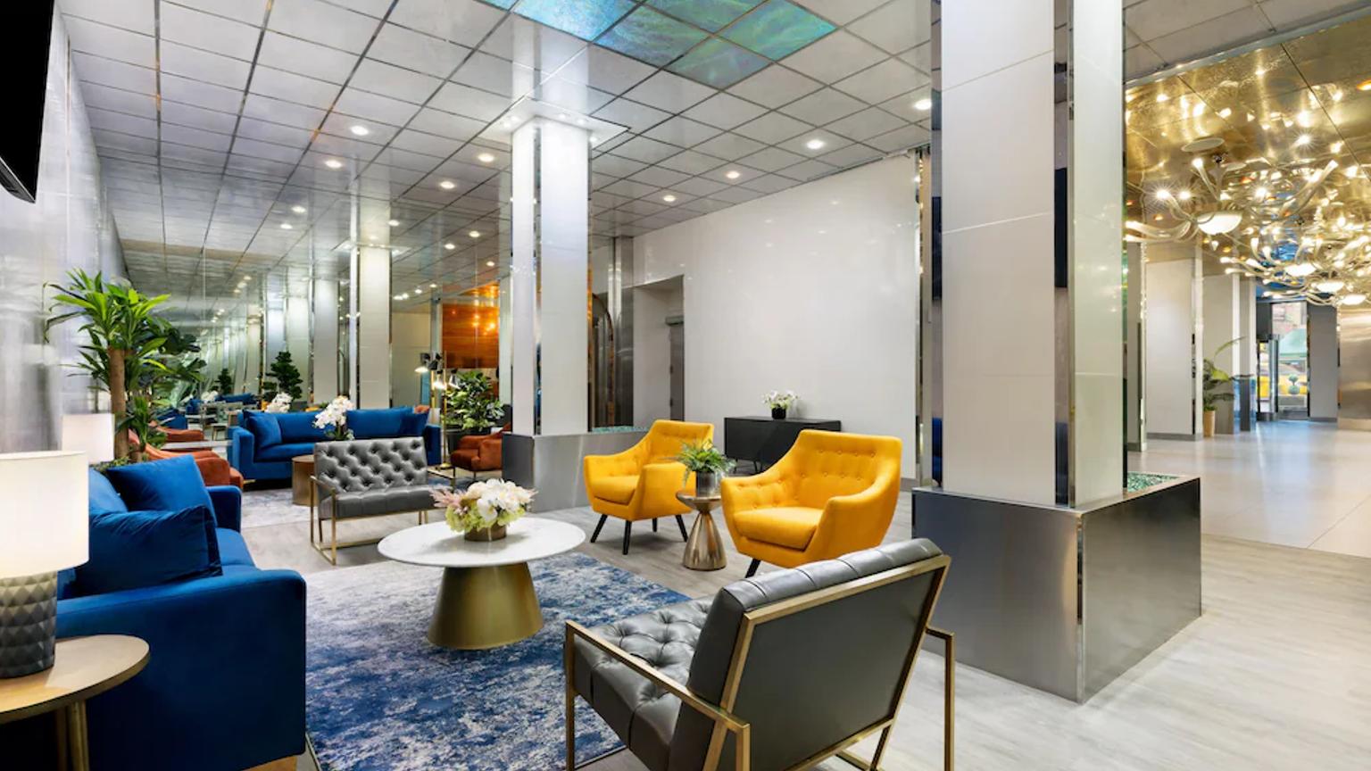 det er mange stoler og en sofa i lobbyen på et hotell