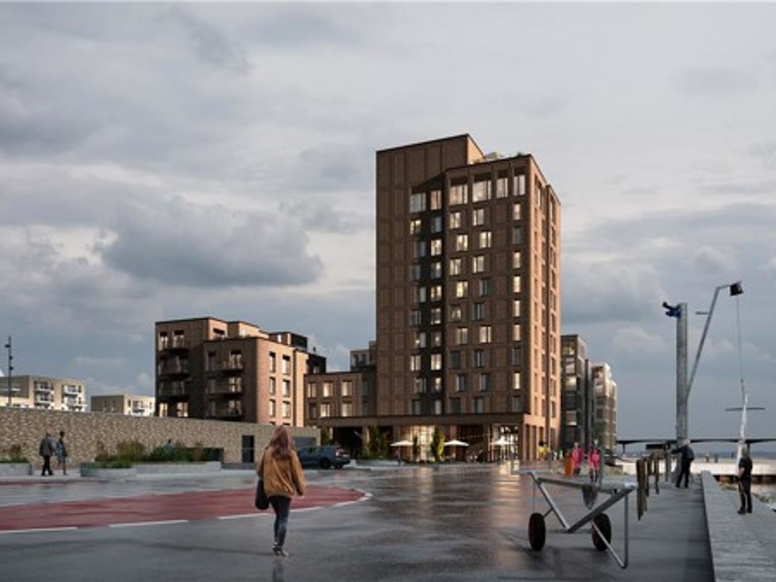 en kvinde går ned ad en fortov foran en stor bygning