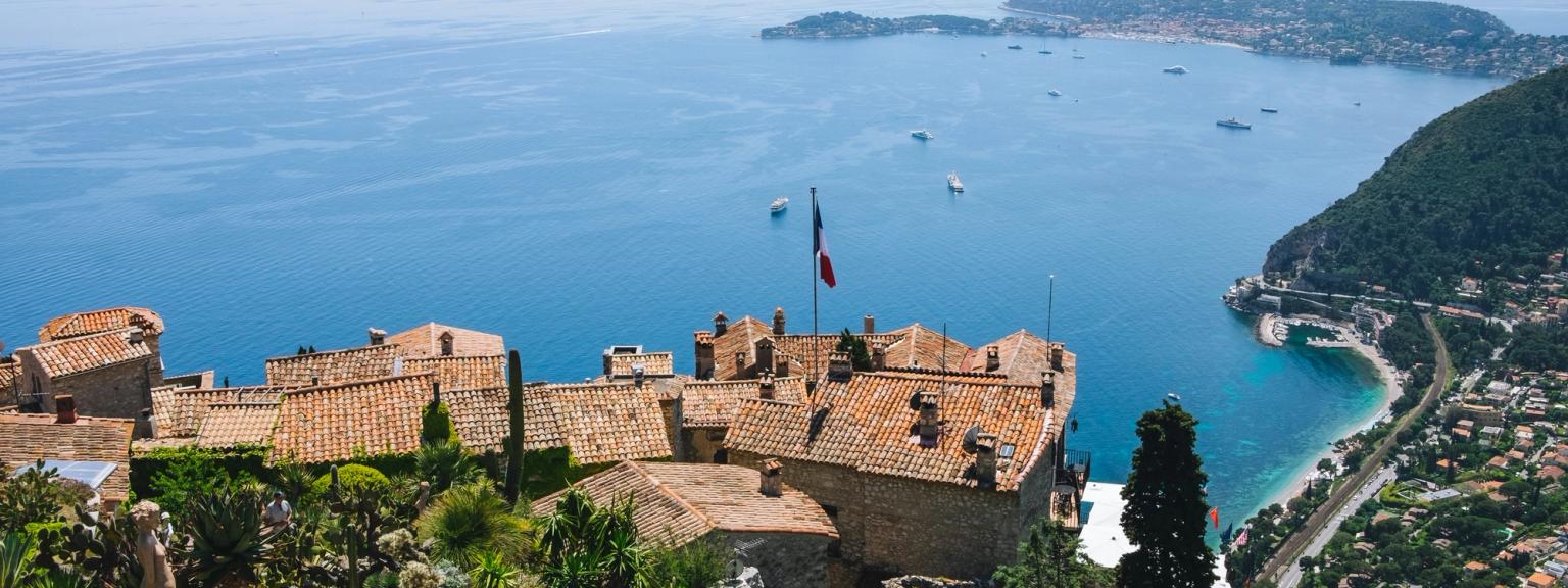 en flygvy av en liten stad på en kulle med utsikt över havet
