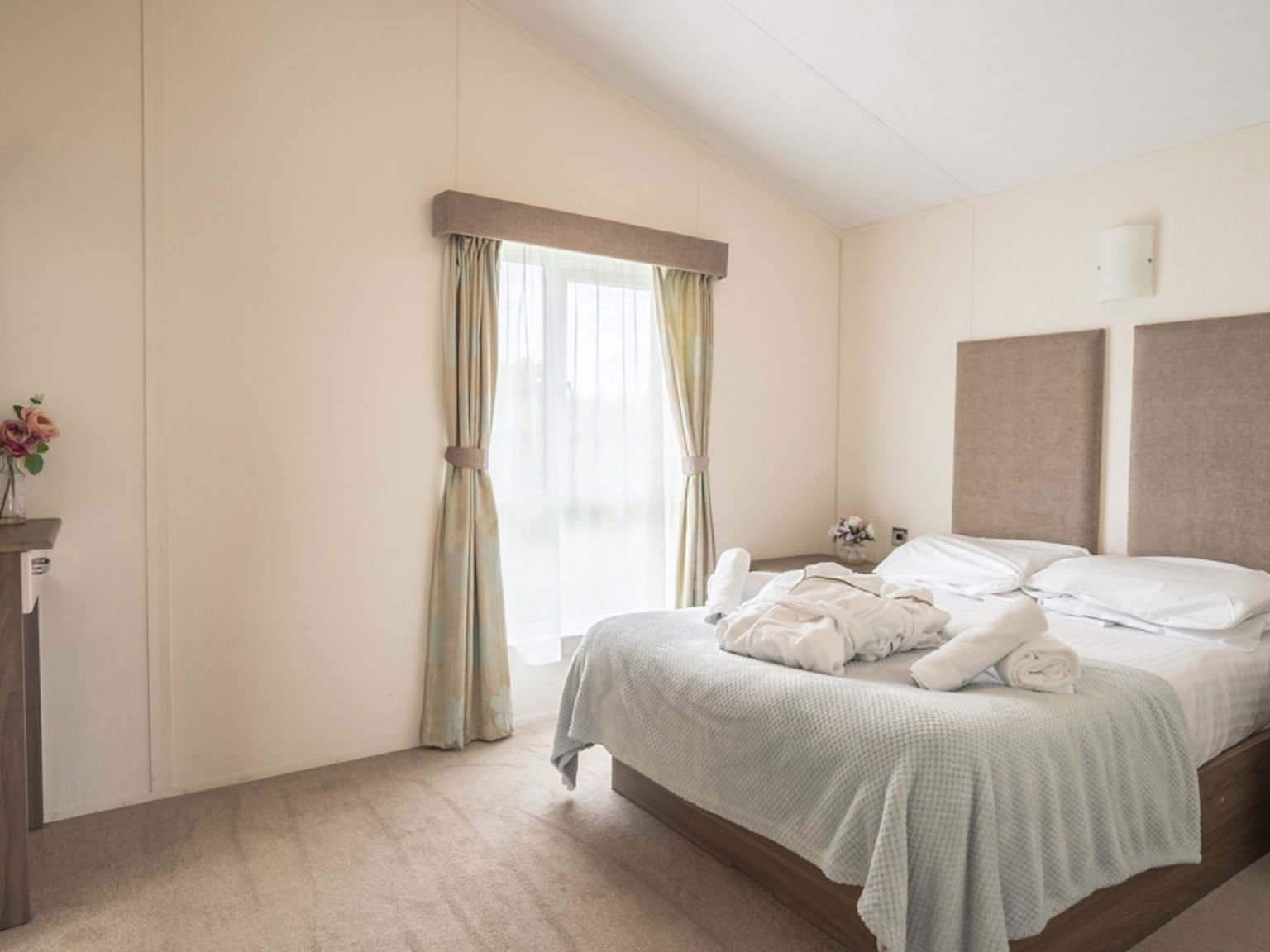 there is a large bed in the middle of the room.