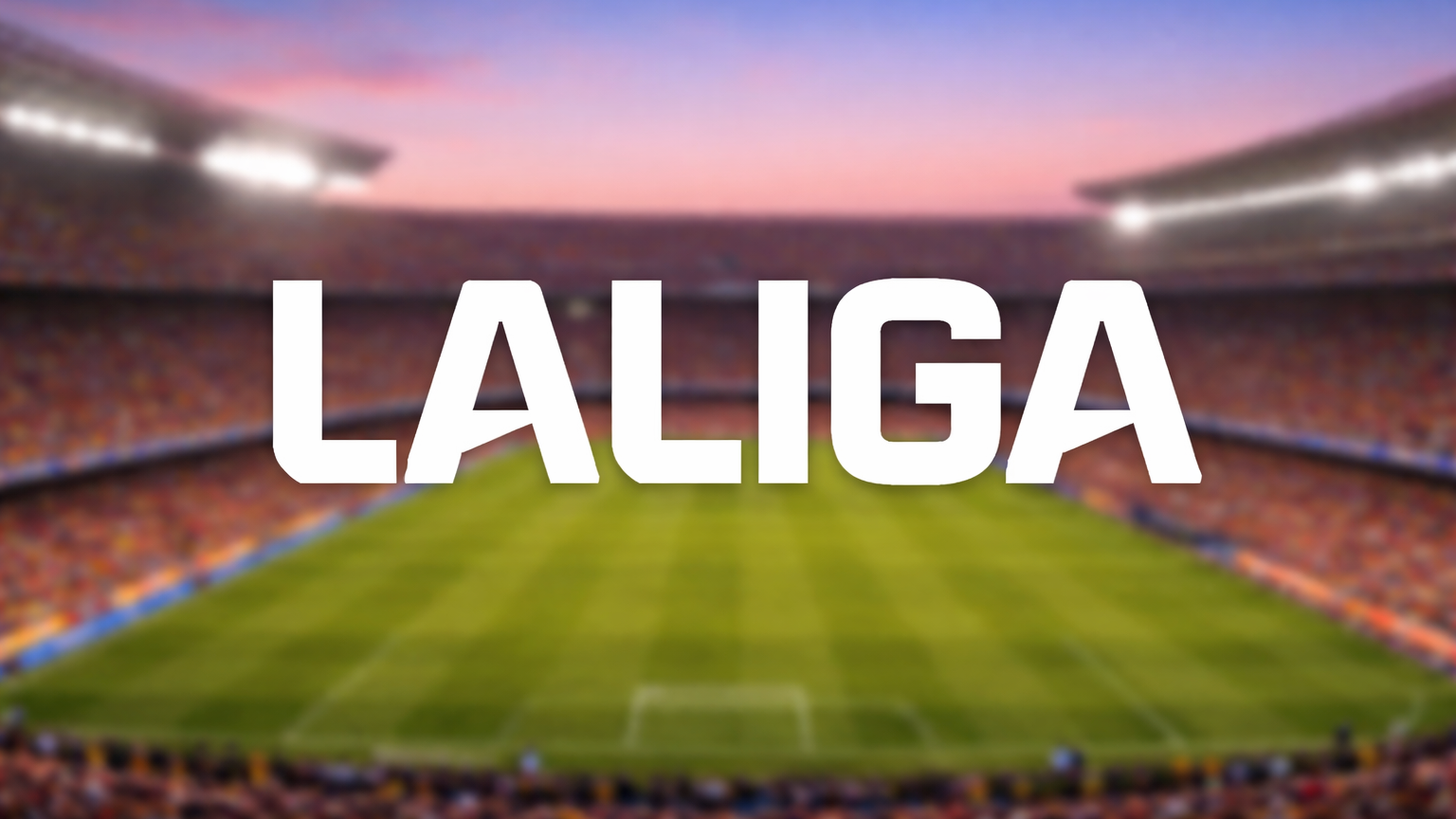 LALIGA-tekst over et sløret fodboldstadion i skumringen.