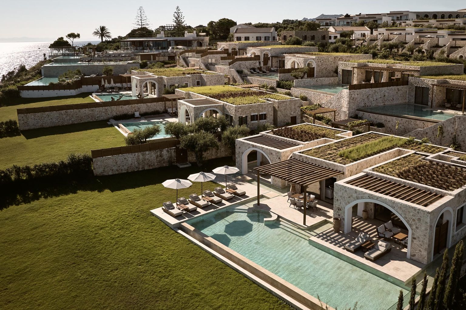 en flygvy av en stor swimmingpool omgiven av hus, Lesante Cape - The Leading Hotels of the World, Zakynthos