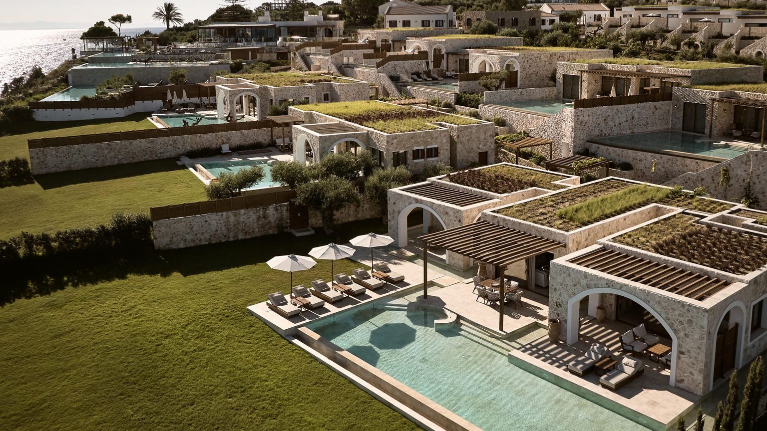 en flygvy av en stor swimmingpool omgiven av hus, Lesante Cape - The Leading Hotels of the World, Zakynthos