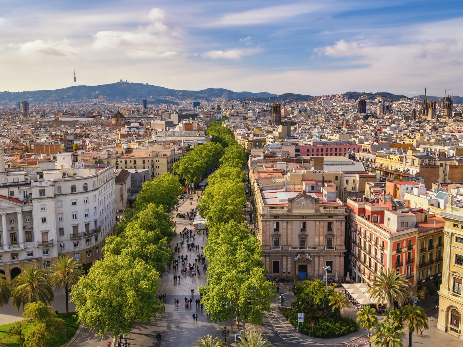 an aerial view of Barcelona with lots of buildings and trees.