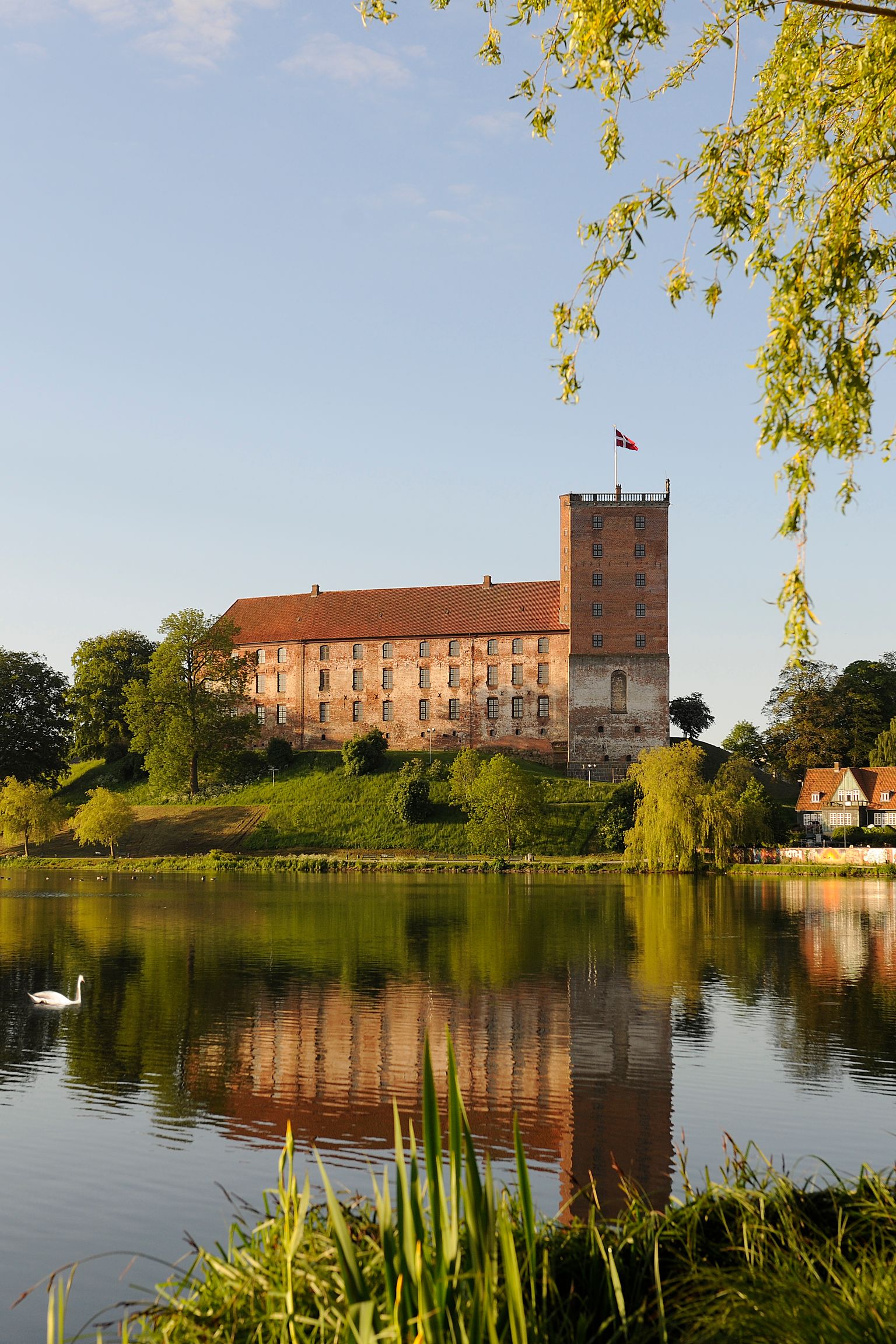 ett stort slott speglas i vattnet av en sjö