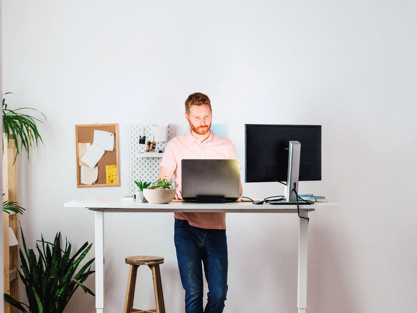 Man standing working on desktop 1