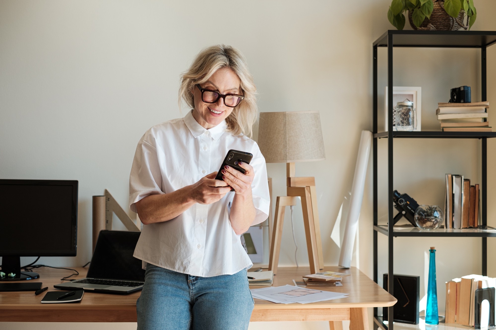 Woman checking phone older table
