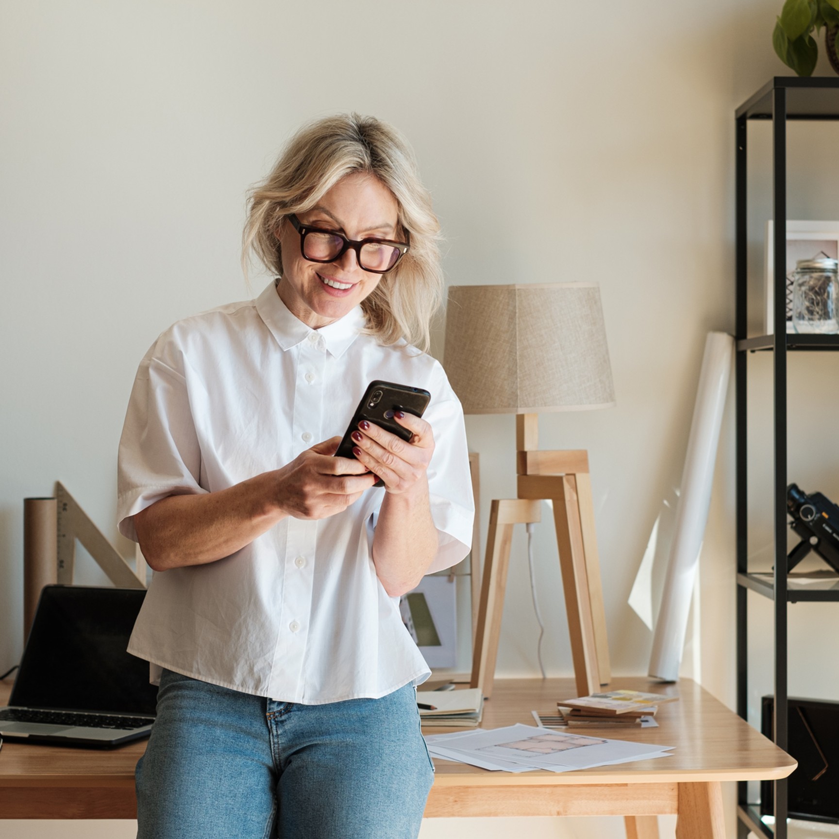 Woman checking phone older table