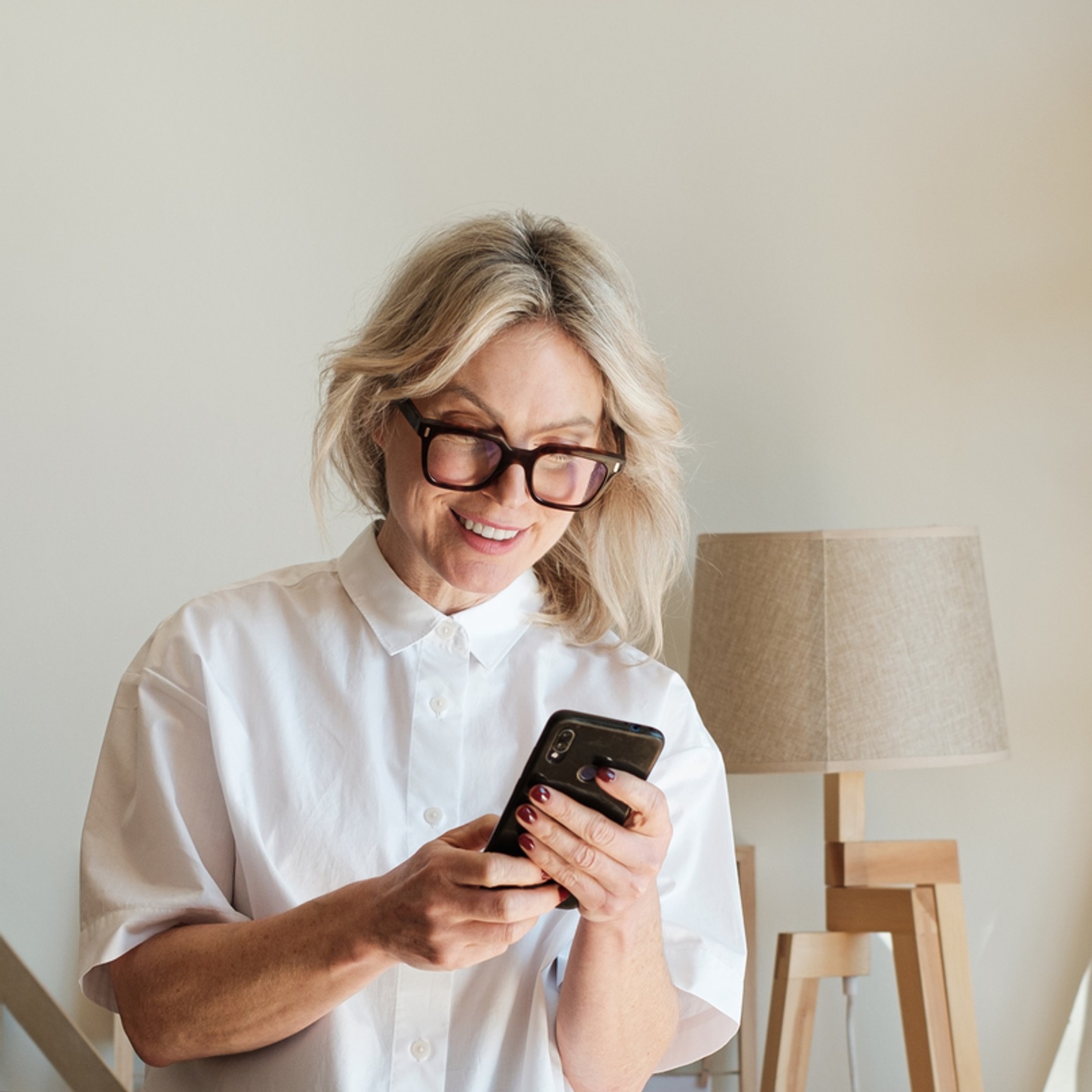 Woman checking phone older table