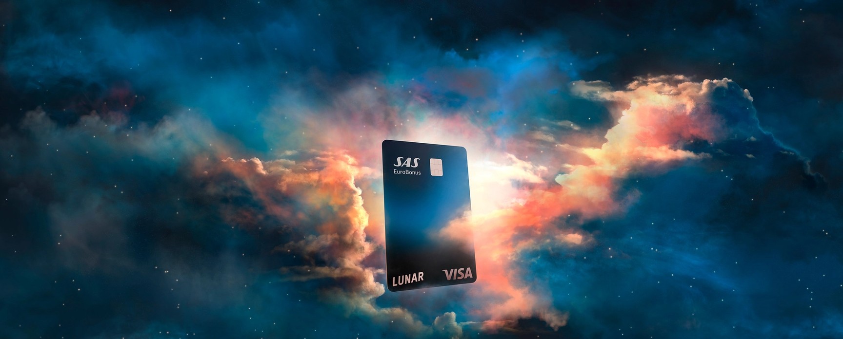 A Lunar SAS EuroBonus Visa card floating amongst colorful, dream-like clouds under a starry night sky.