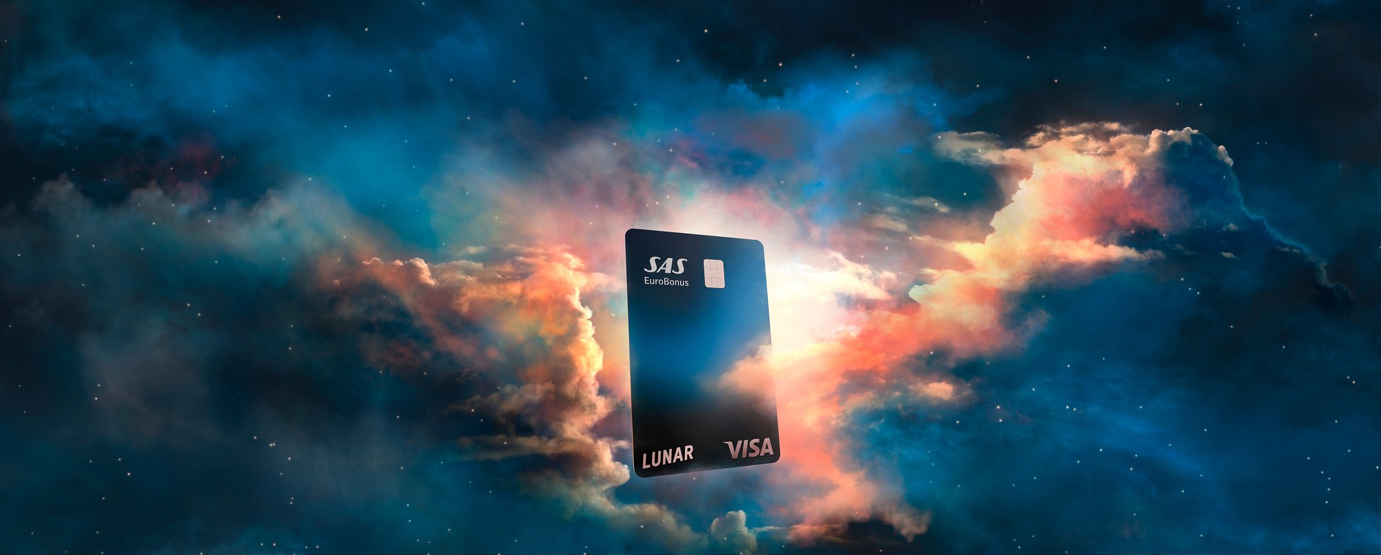 A Lunar SAS EuroBonus Visa card floating amongst colorful, dream-like clouds under a starry night sky.