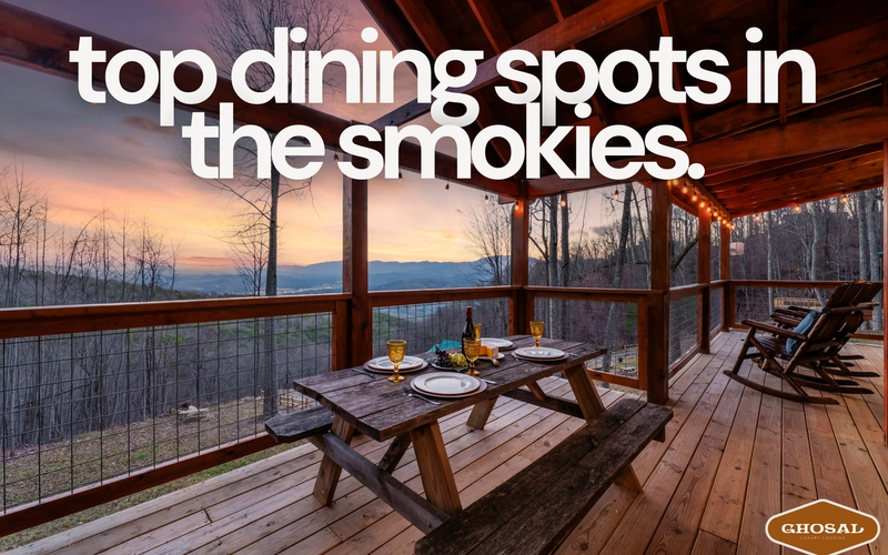 A wooden picnic table set for dinner sits on a covered deck overlooking mountains at sunset, with text reading top restaurants Smoky Mountains. The cozy, rustic scene offers scenic views and highlights must-visit Smokies dining spots.