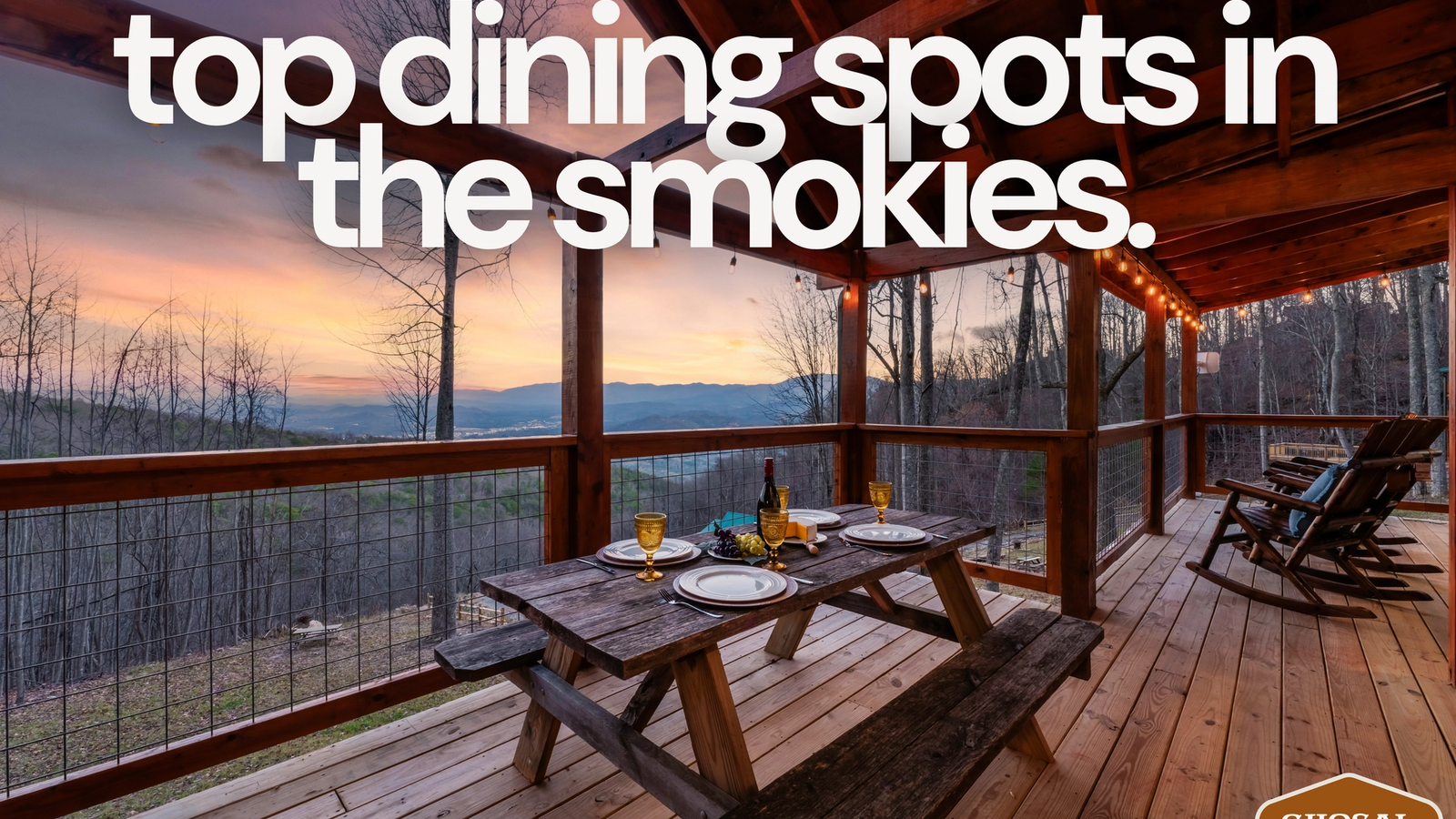 A wooden picnic table set for dinner sits on a covered deck overlooking mountains at sunset, with text reading top restaurants Smoky Mountains. The cozy, rustic scene offers scenic views and highlights must-visit Smokies dining spots.