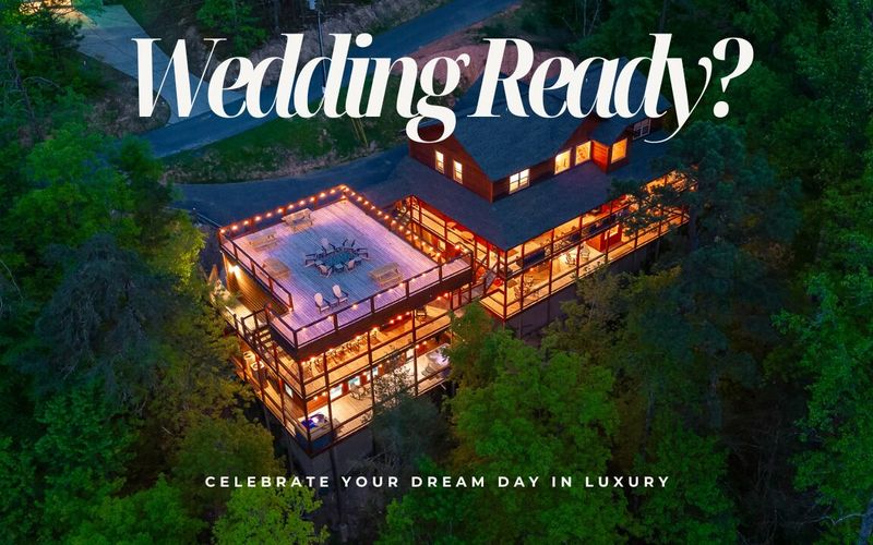 Aerial view of a large, well-lit cabin surrounded by trees at dusk with text overlay: Wedding Ready? Discover one of the top wedding venues and celebrate your dream day in luxury.