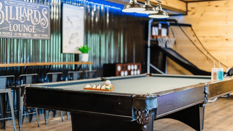 A wide shot of a pool table, with the balls ready in the rack.
