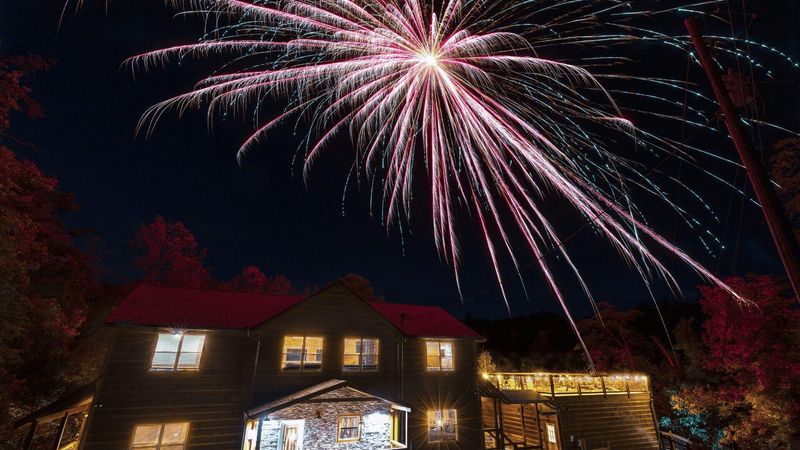 Fireworks over a cabin.