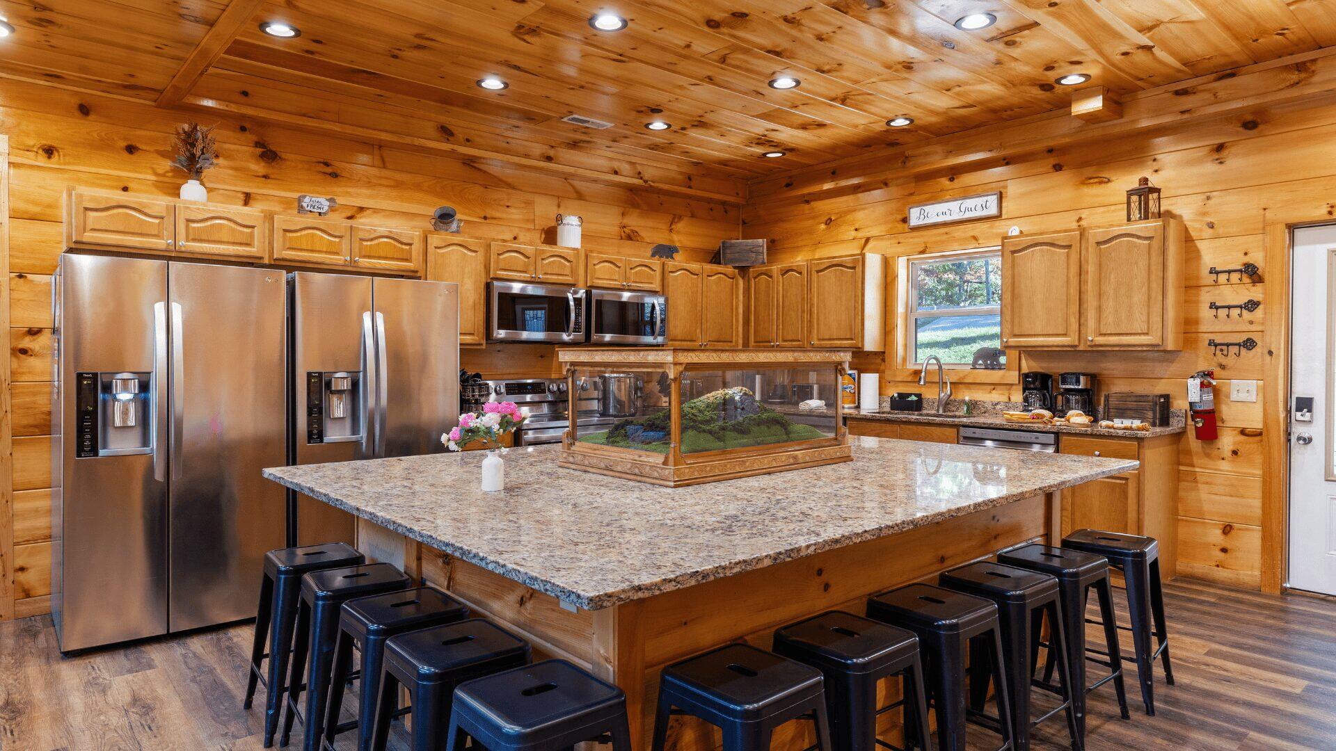 A rustic decorated kitchen, with a large island in the middle.