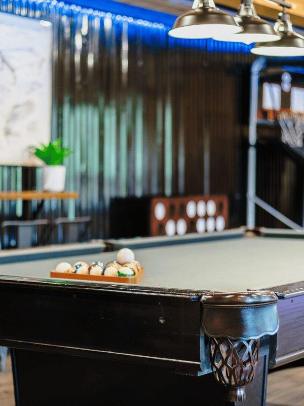 A wide shot of a pool table, with the balls ready in the rack.