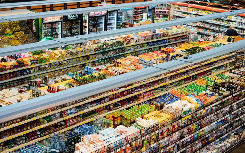 Aerial view of Gatlinburg grocery stores, with aisles filled with colorful packaged food and drink products, including beverages, snacks, and groceries, all neatly organized on shelves.