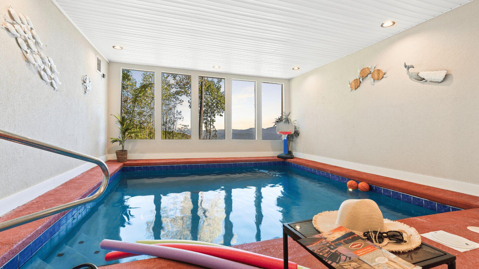An indoor pool with a view of the valley.