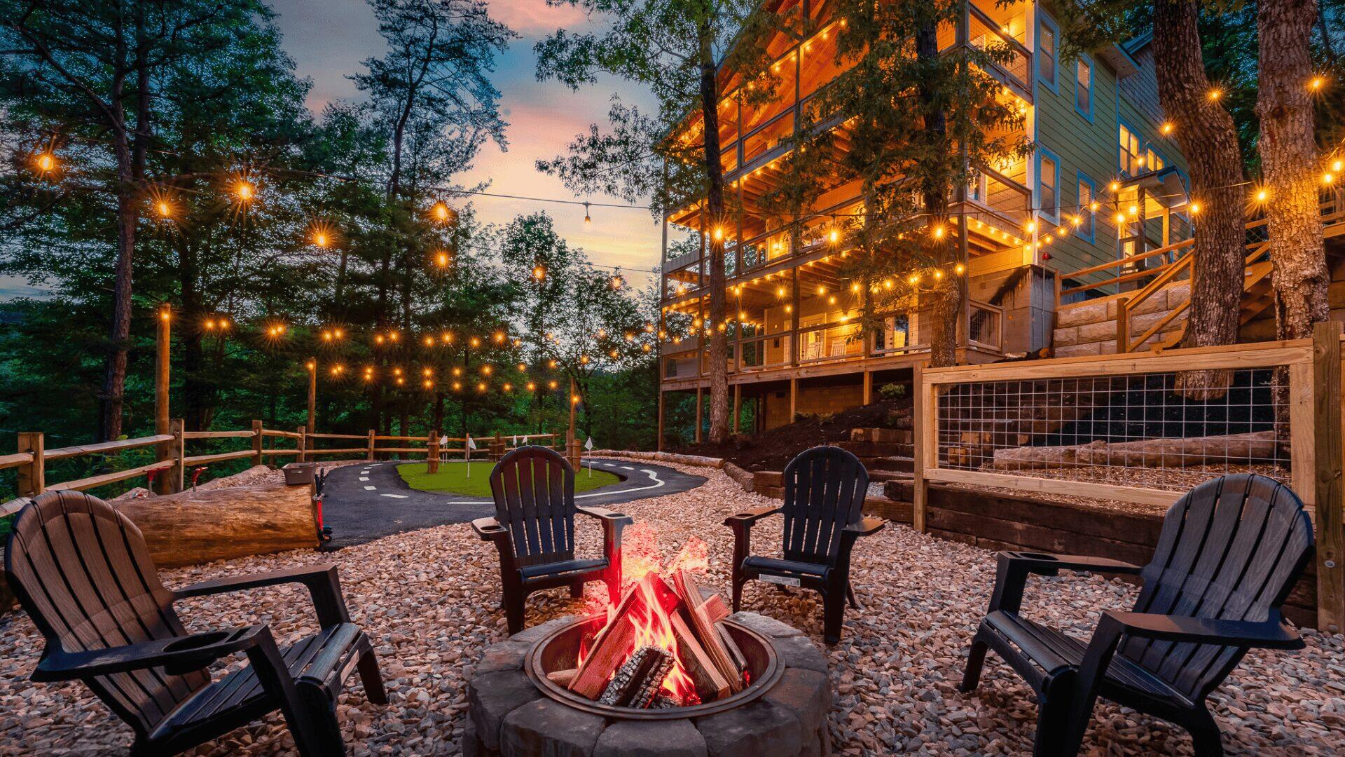 An outside area with chairs positioned around a fire.