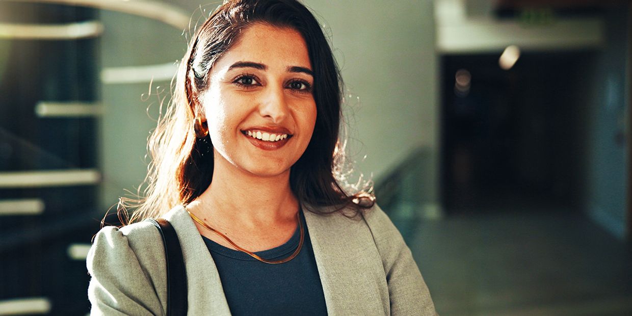 Confident smiling woman outdoors, representing positive transformation, clarity, and empowerment after receiving a career psychic reading.