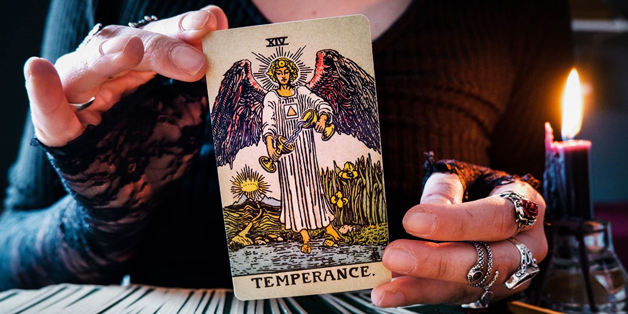 Tarot card Temperance held by a psychic, symbolising balance in love.