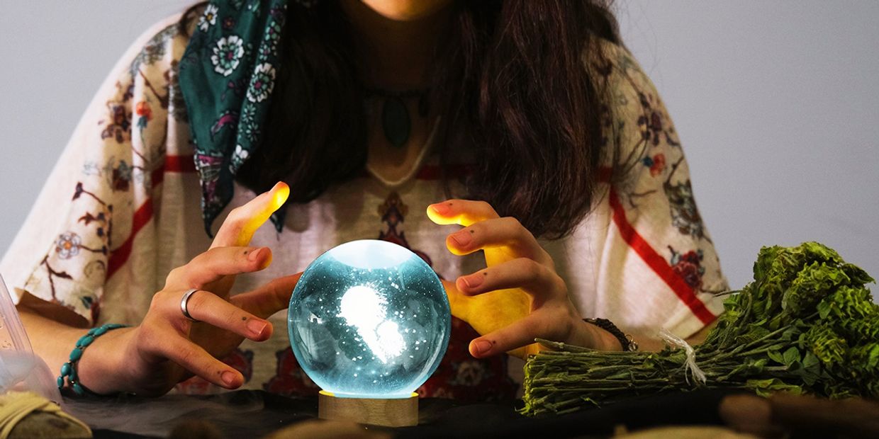 A clairvoyant reader using her crystal ball