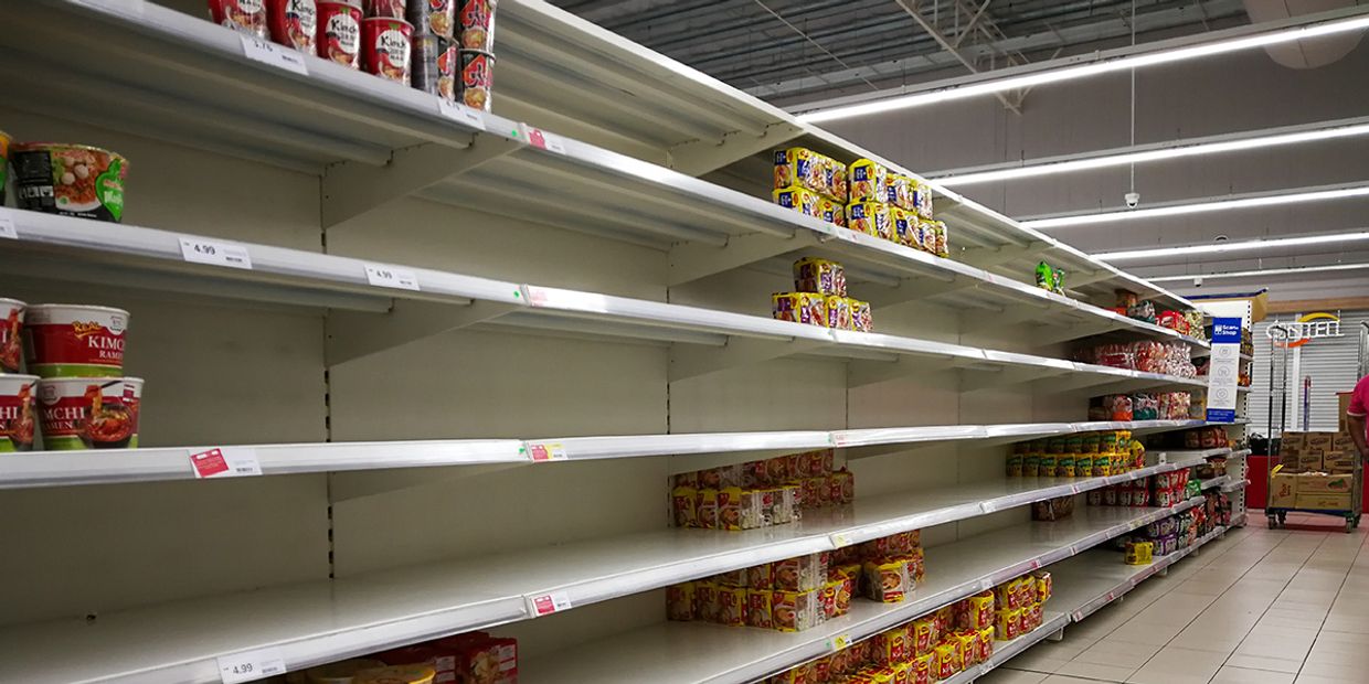 A shop full of empty food shelves.