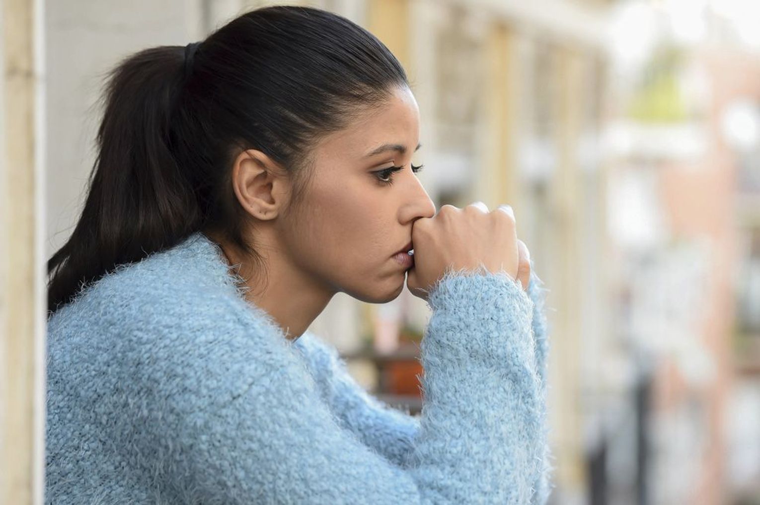 Young woman thinking and looking worried