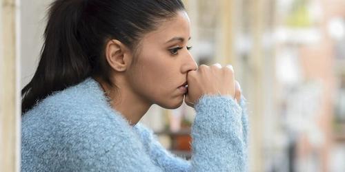 Young woman thinking and looking worried