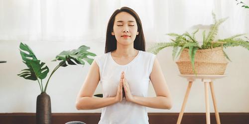 A woman meditating in a light space
