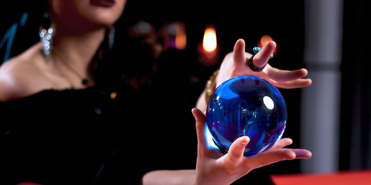 Trusted Psychics Reviews & Online Psychic Readings - A reader holding a crystal ball.