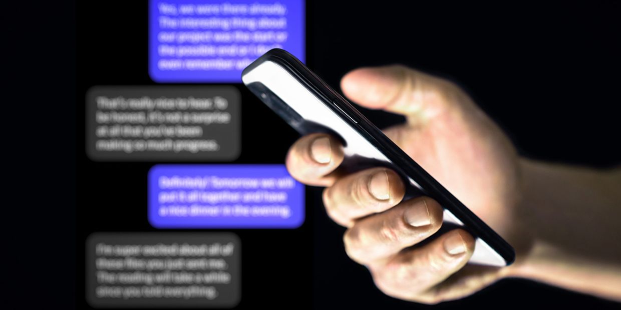 A person holding a phone, discussing potential cheating signs in texts.