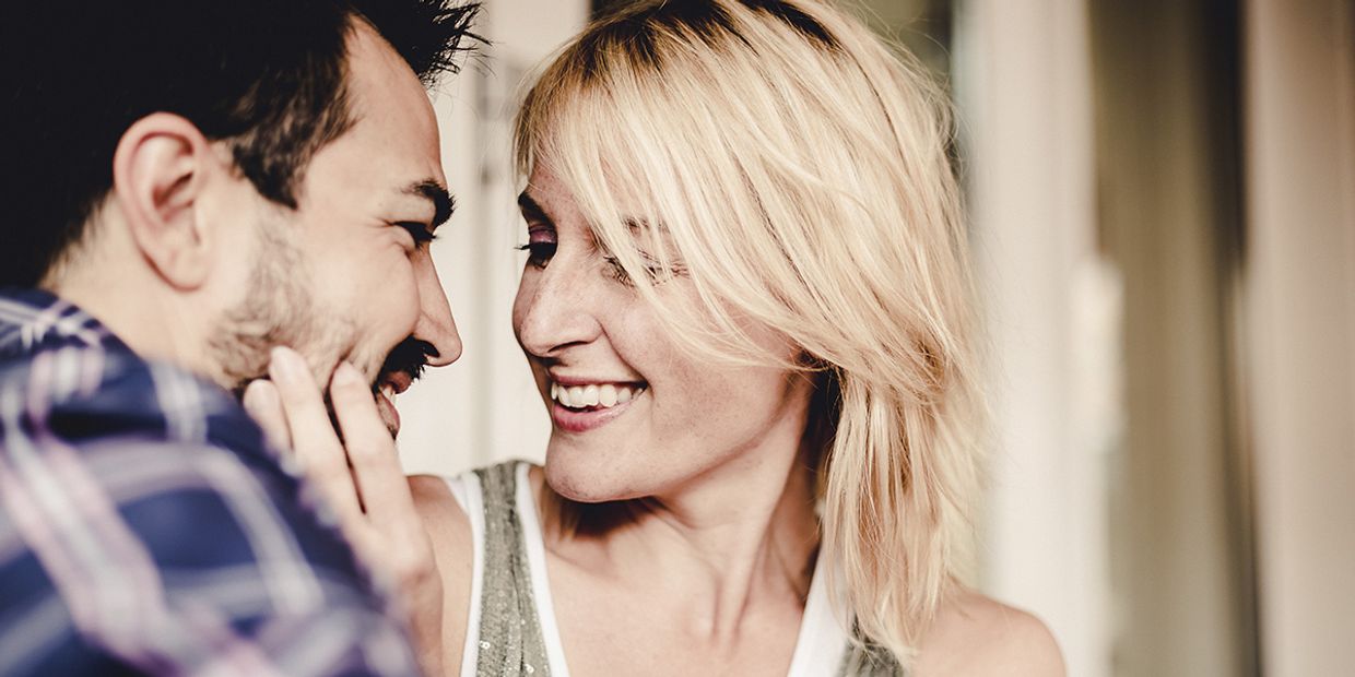 Couple sharing a joyful moment, representing Cancer personality traits.