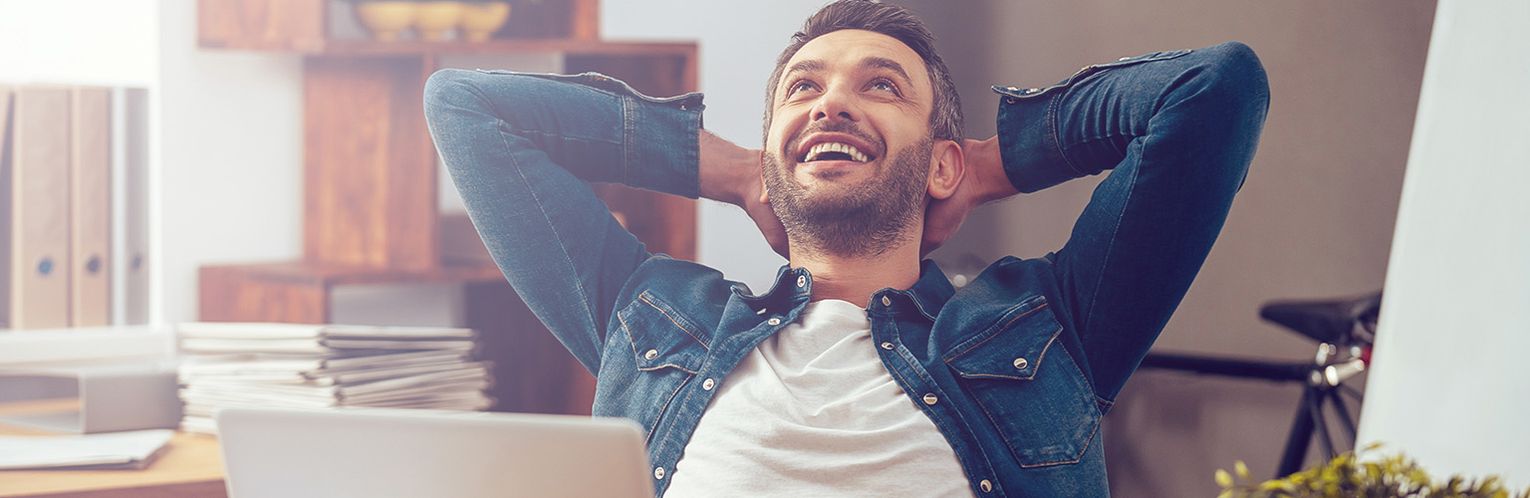 A happy man at his desk in the office