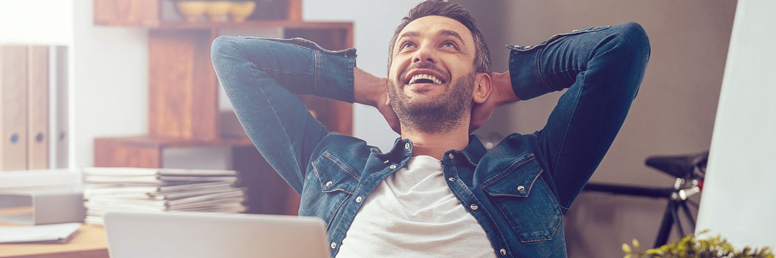 A happy man at his desk in the office